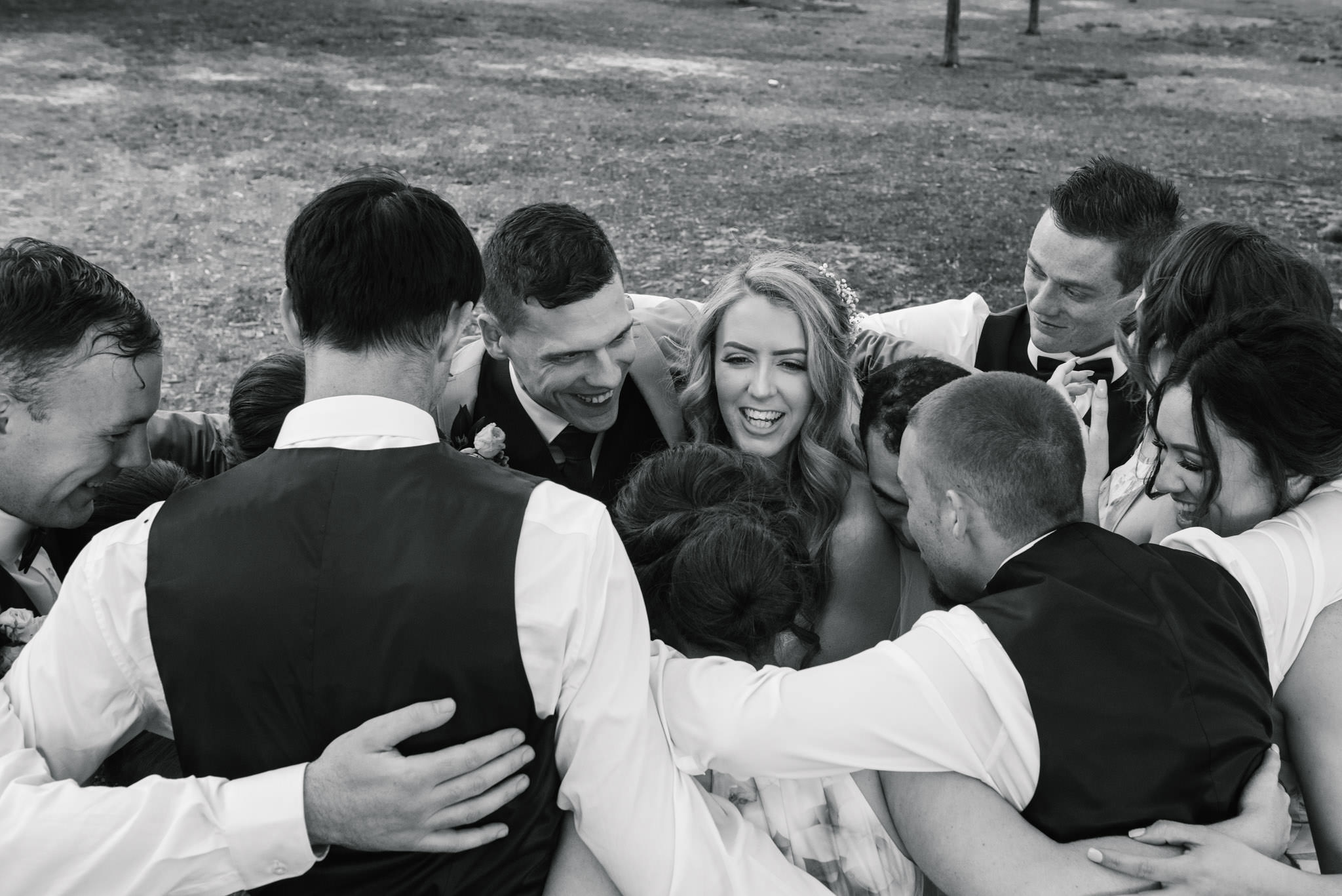 Bridal party gives the newlyweds a group hug