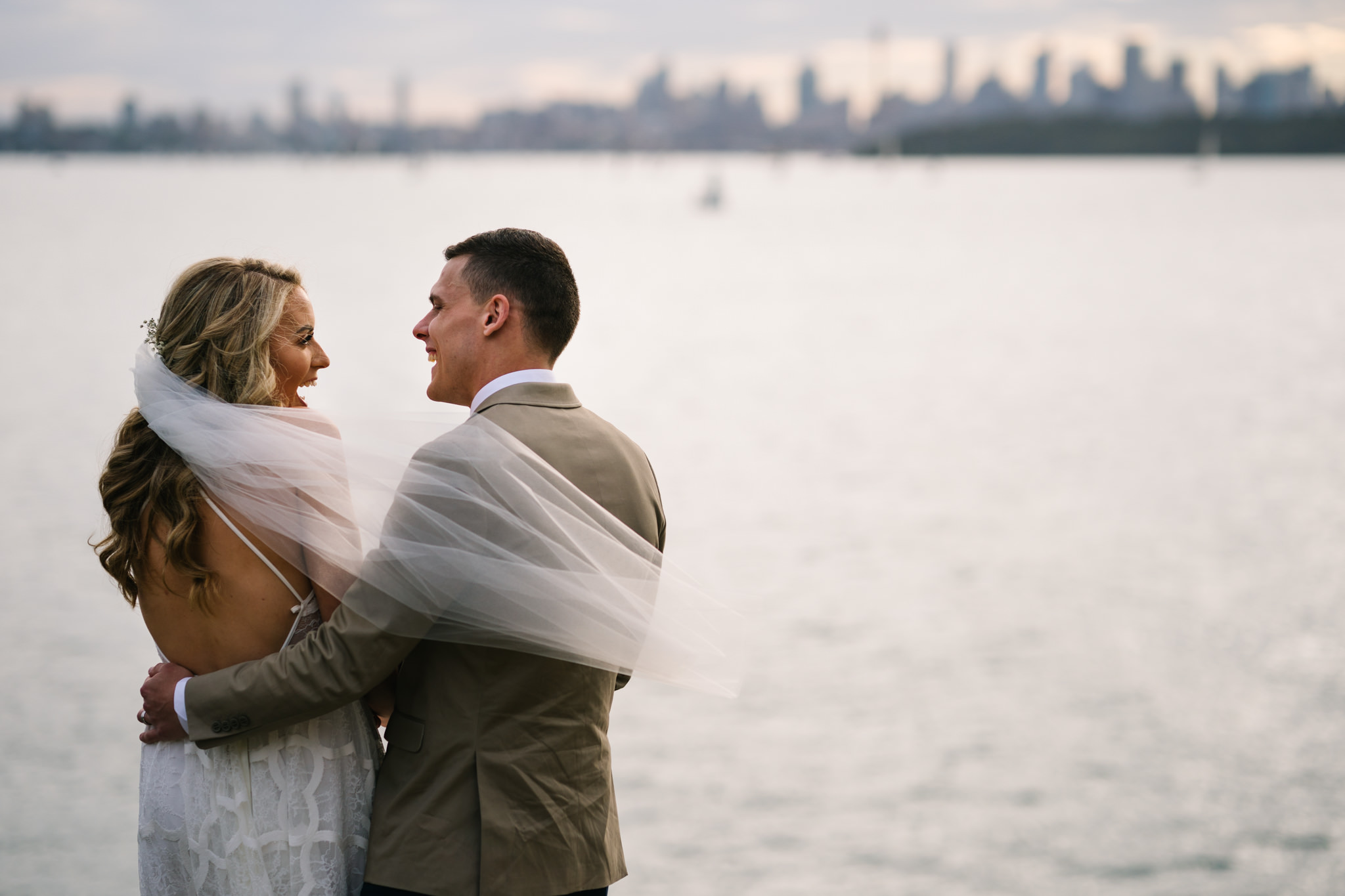 Bride and groom with water views of Camp Cove in the backdrop