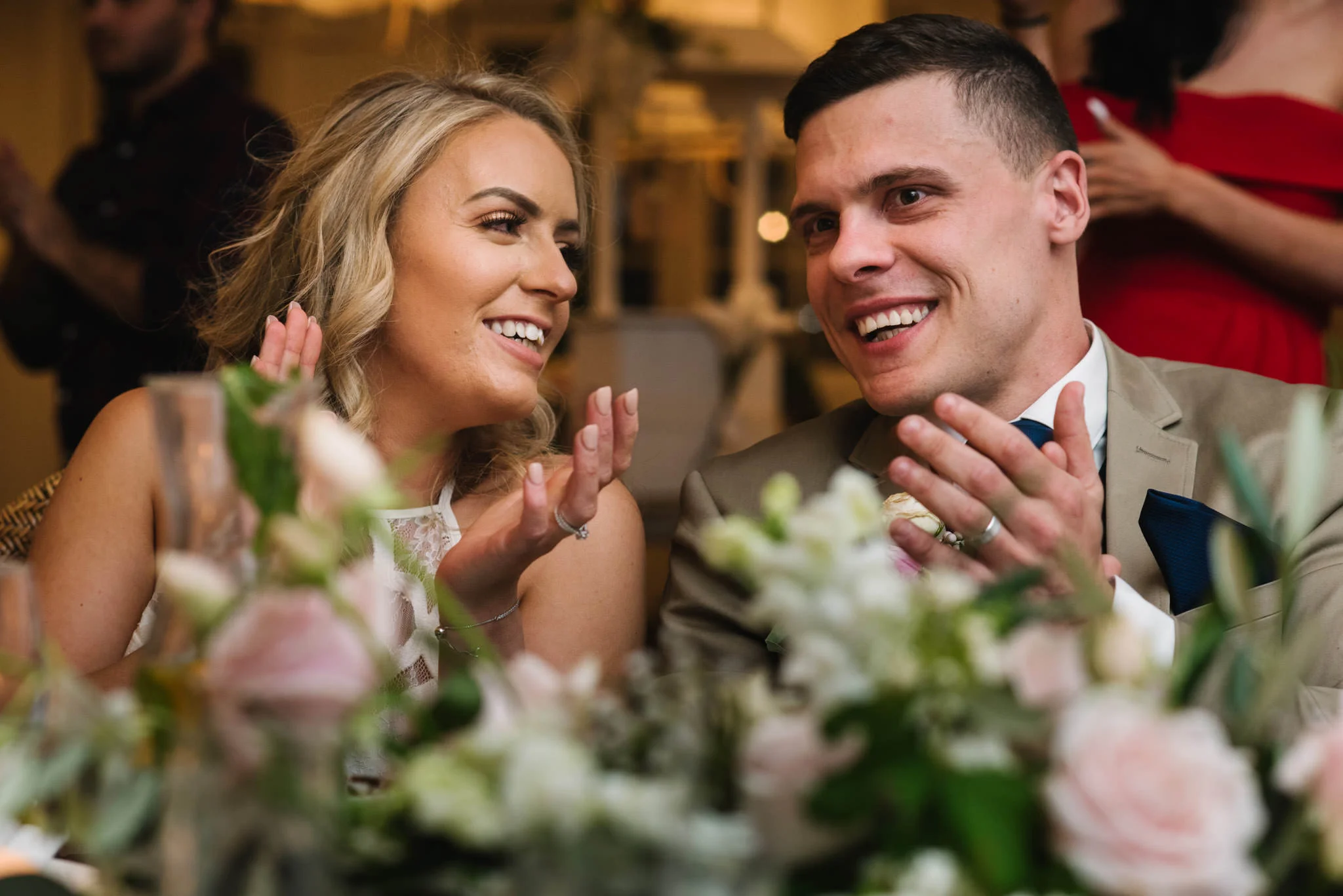Bride and groom laughing during speeches