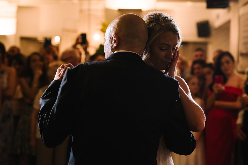 Bride crying as she dances with her dad