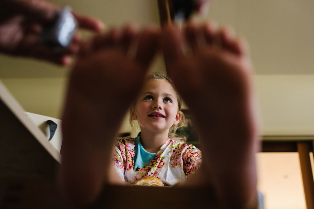 Flower girl getting her toenails painted