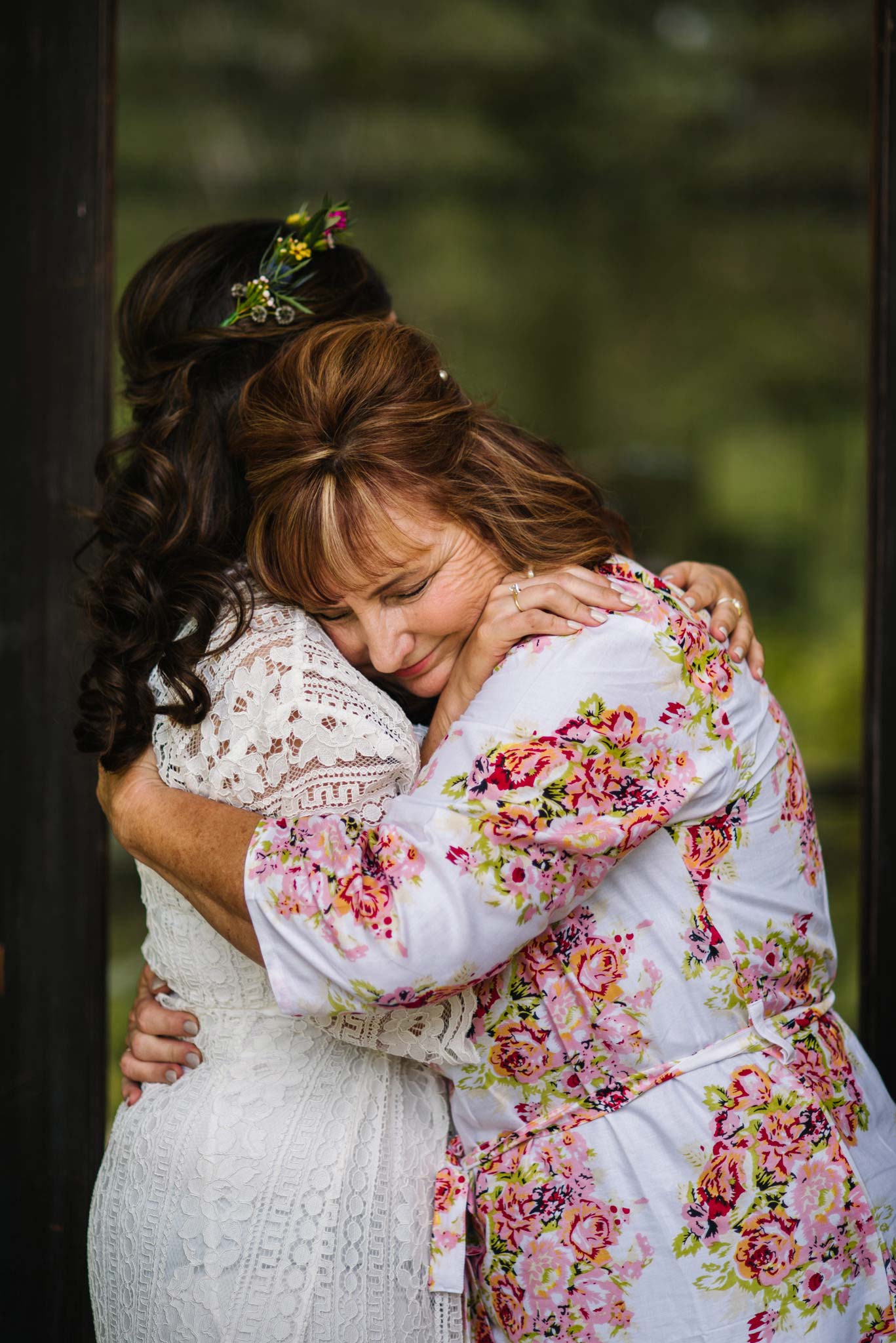 Mother of the bride hugs her daughter tightly