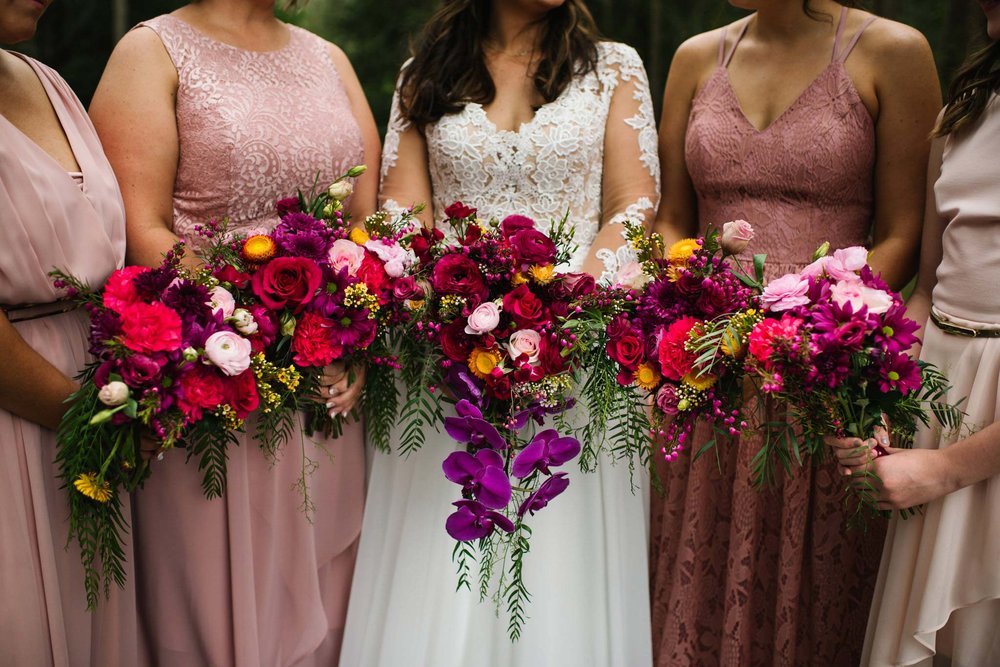 Colourful bouquets held by bride and bridesmaids