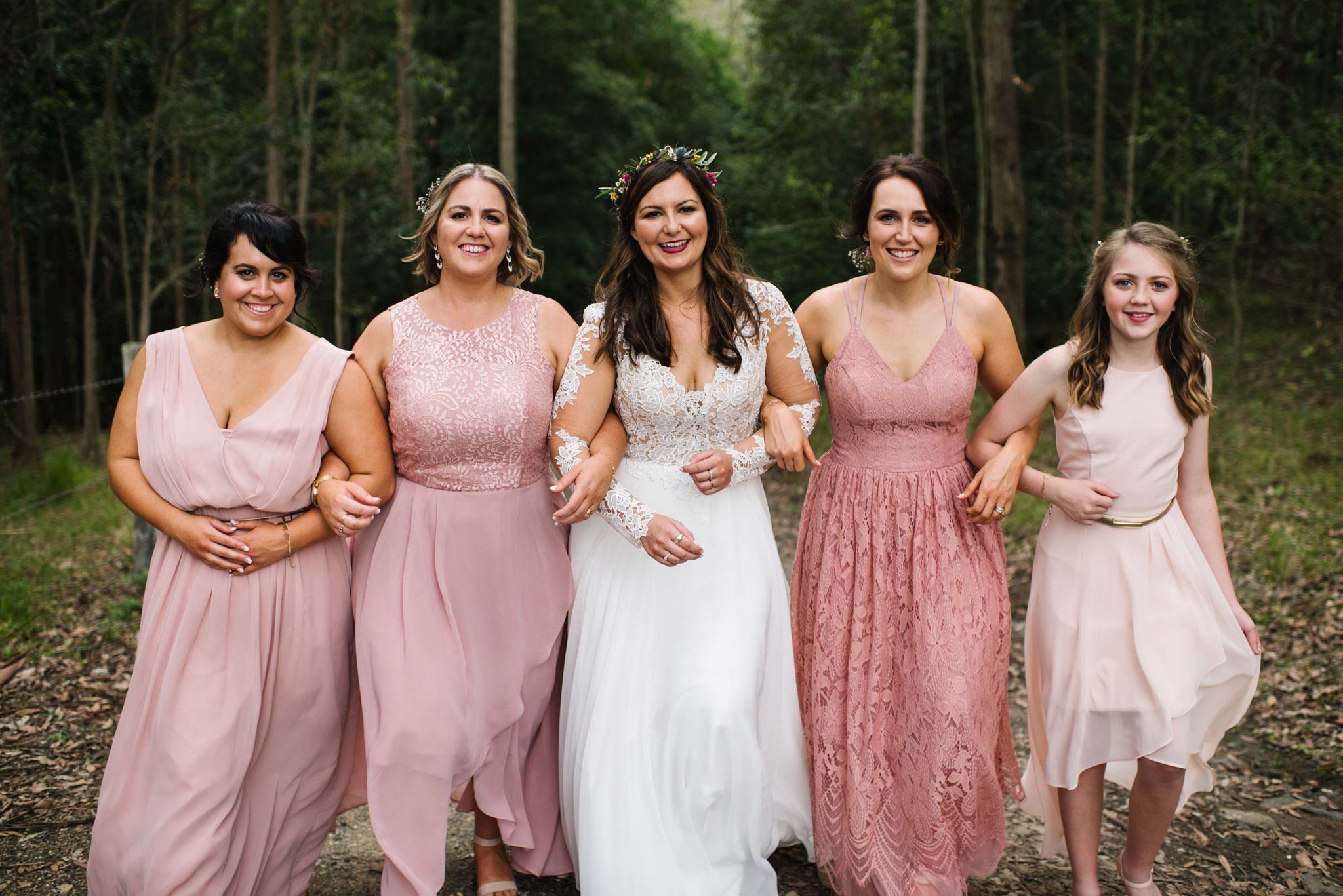 Bride and bridesmaids in various shades of pink