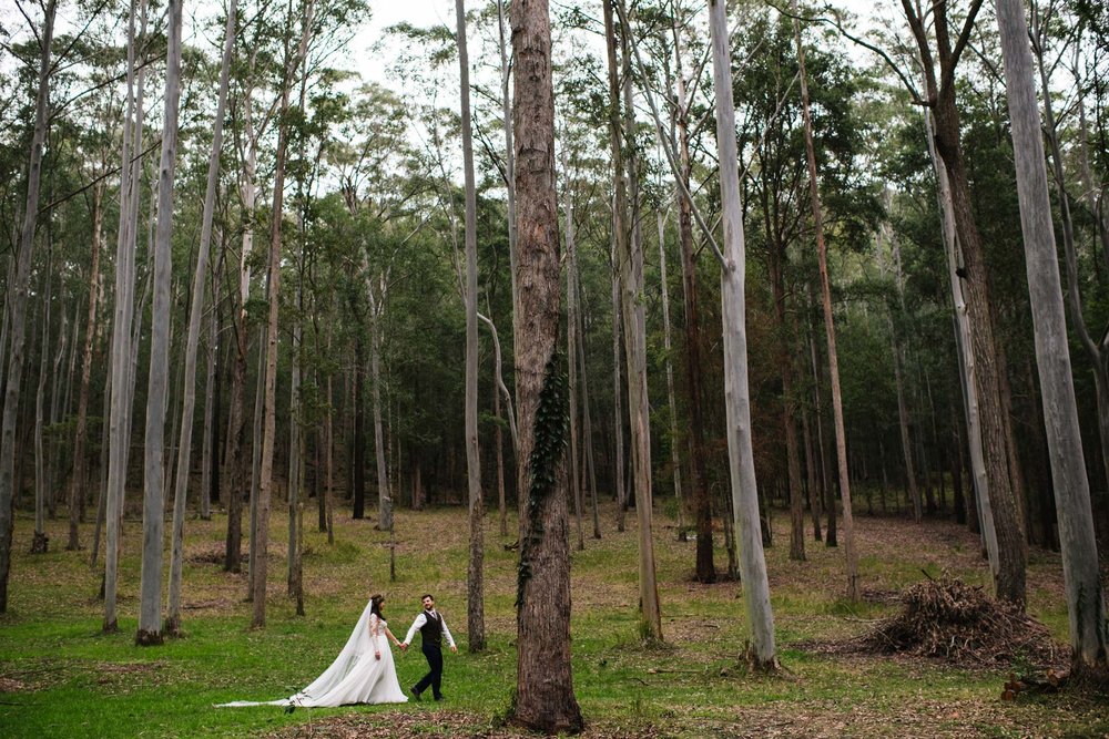 Newlyweds walk through the forest in country NSW