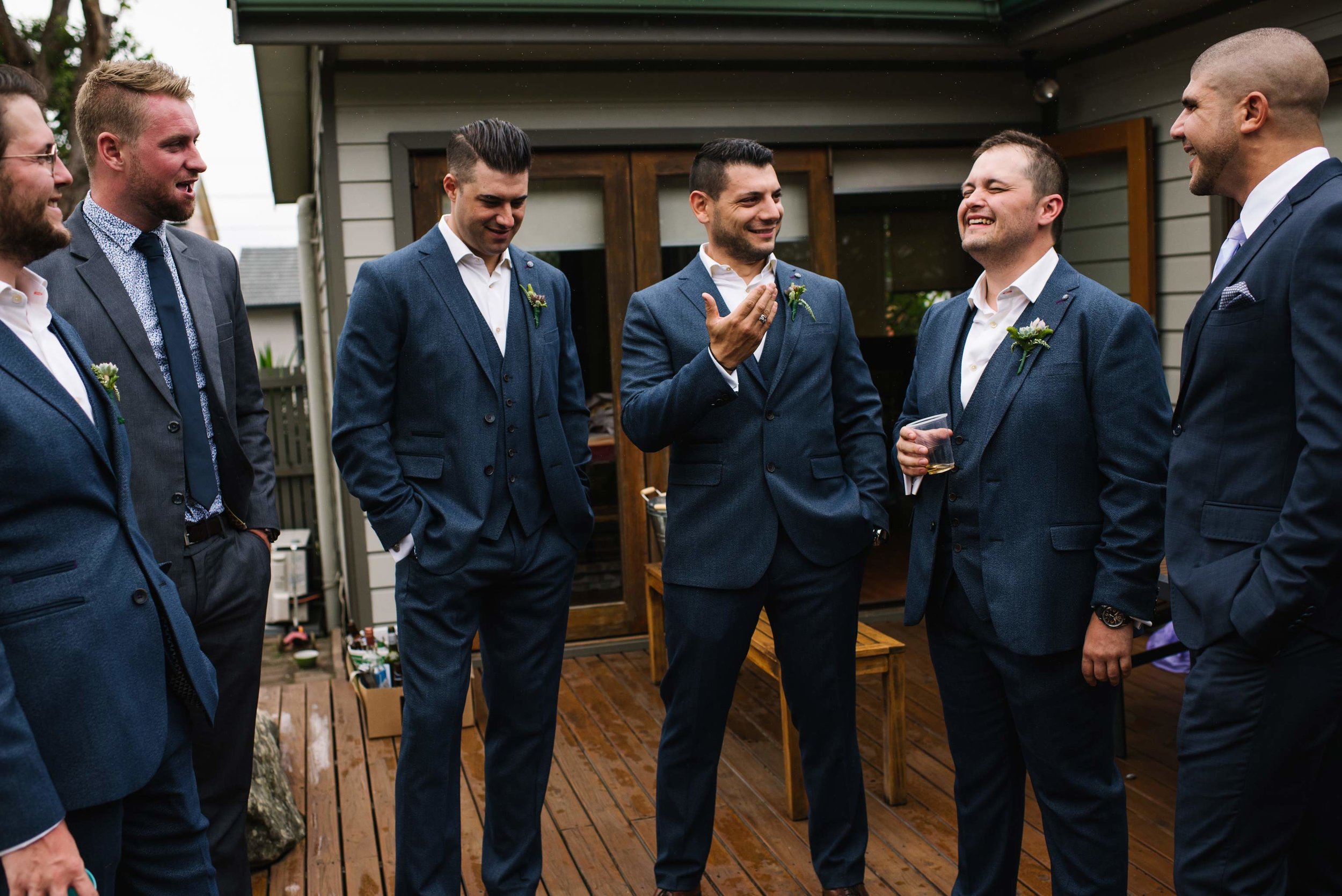 Groomsmen and groom laughing before ceremony