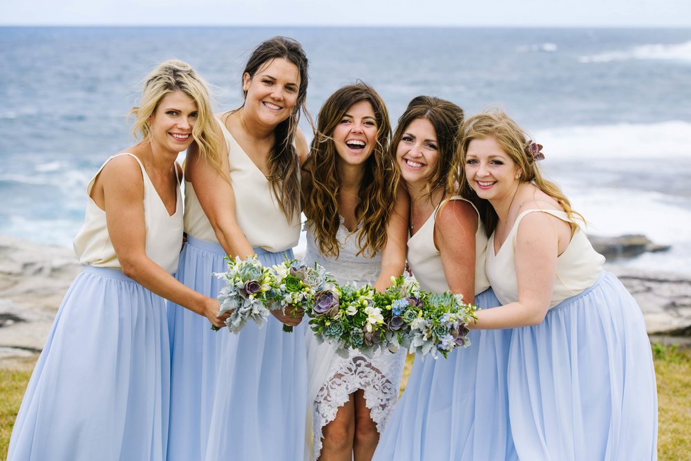 Bridesmaids in blue and white beachy dresses