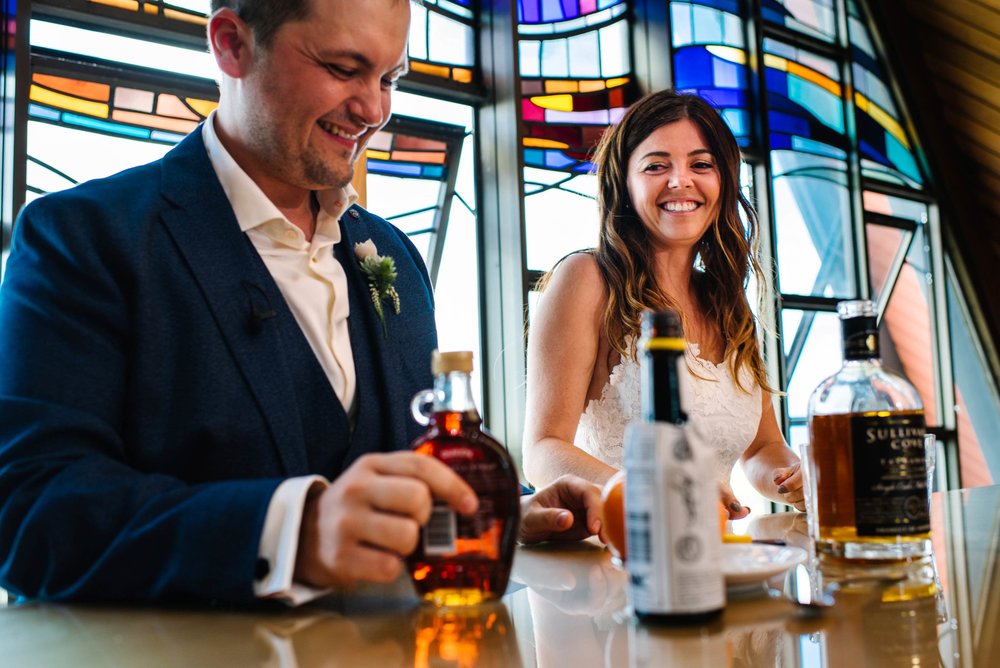 Bride and groom prepare an Old Fashioned during wedding service