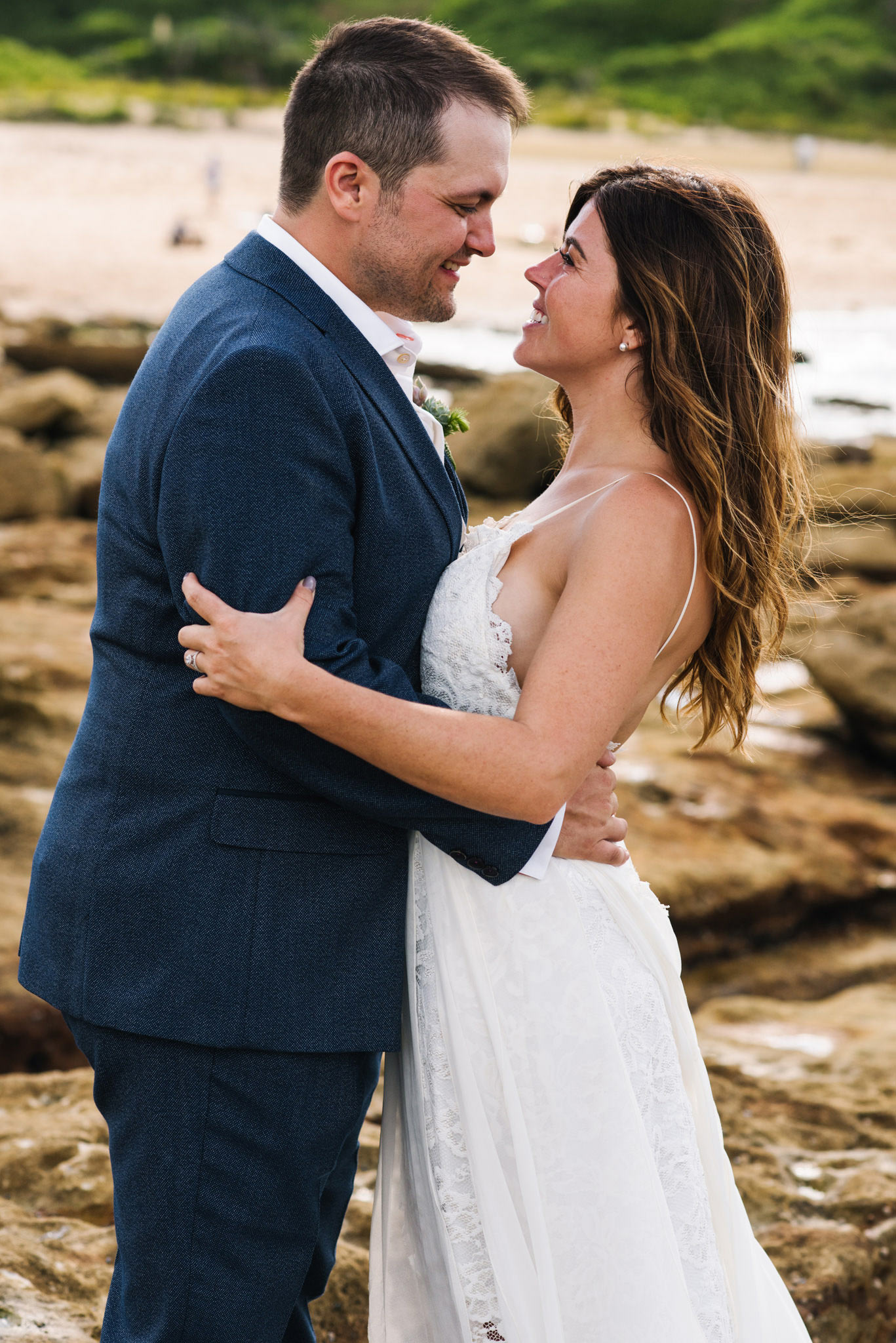 Bride and groom embrace on Sydney beach