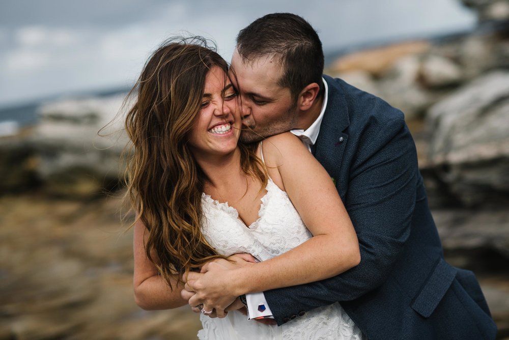 Bride and groom cuddling and smiling