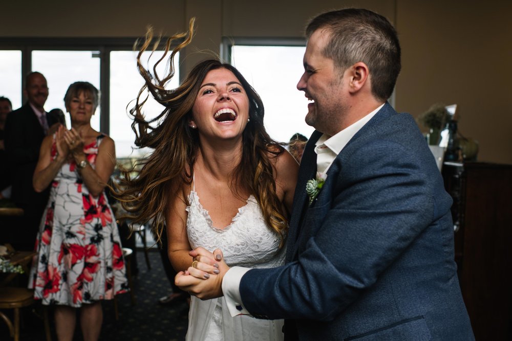 Bride laughing during entrance to wedding reception