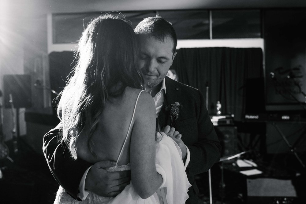 Groom smiling during first dance