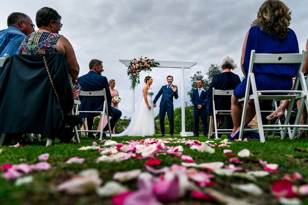 Wedding ceremony in park above Shelly Beach with altar and colourful flowers