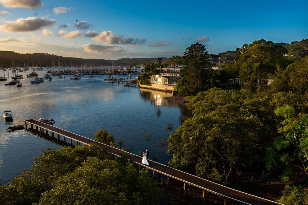 View of couple walking along dock in Bayview