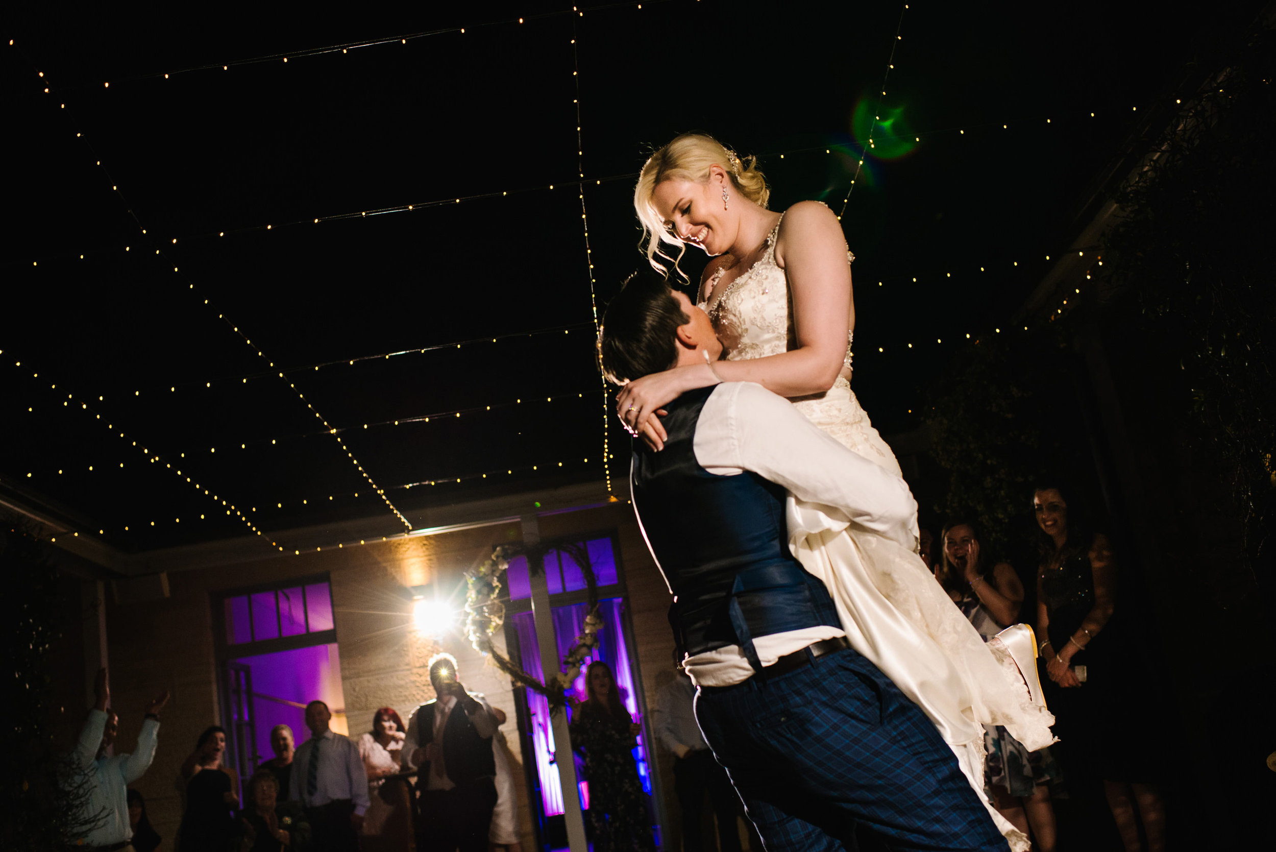 Groom lifts bride during first dance at Gunner's Barracks wedding reception
