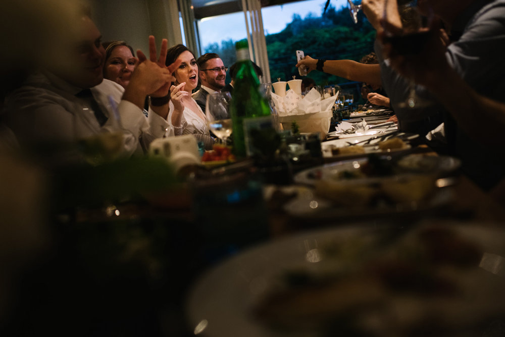 Bride laughing during dinner at Boathouse Shelly Beach wedding