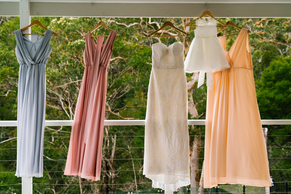 Beachy bridesmaids gowns hanging in front of bushland backdrop