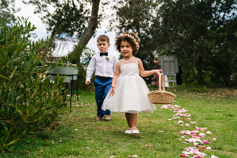 Flower girl and ring bearer walking down aisle