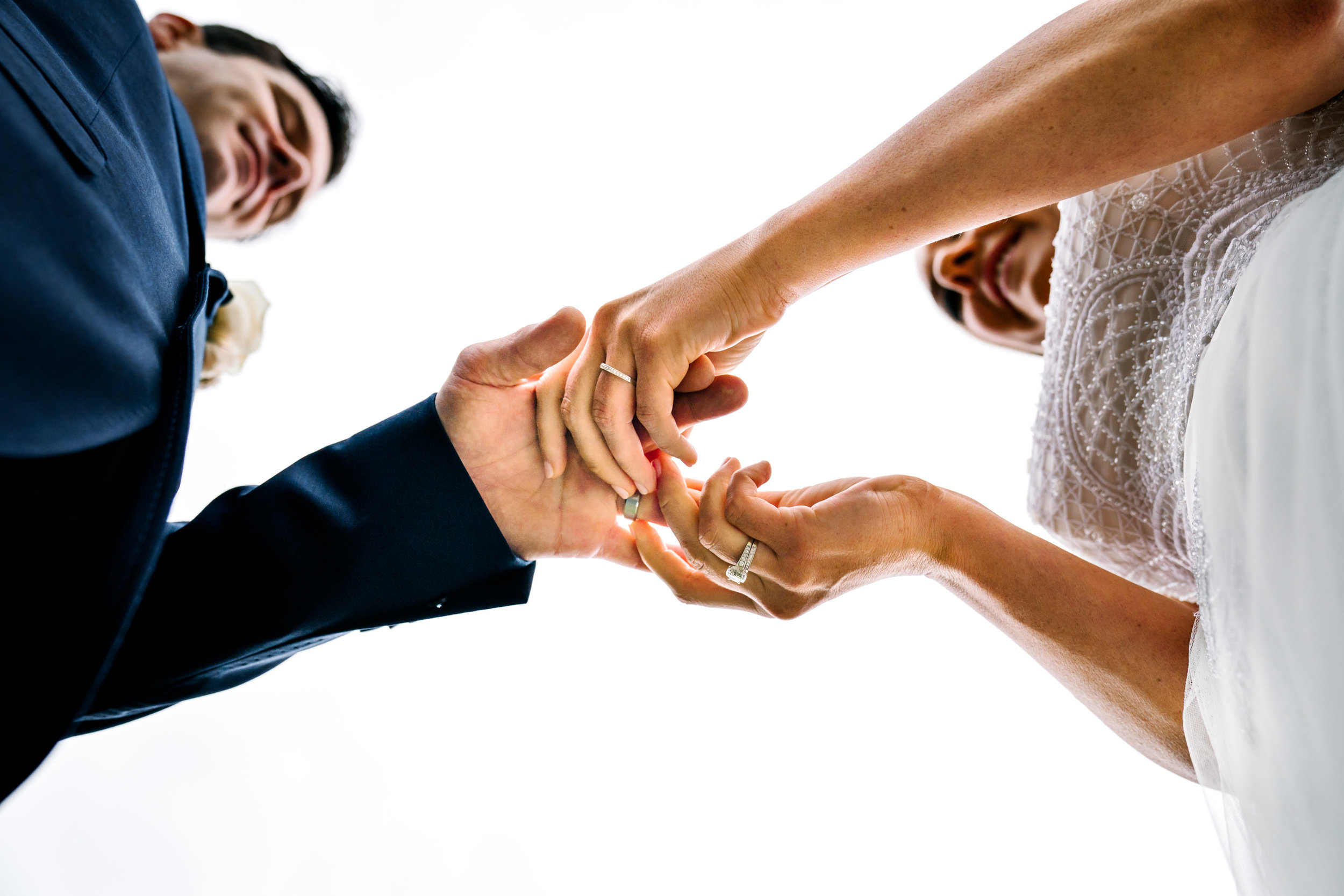 Bride and groom exchange rings, view from below