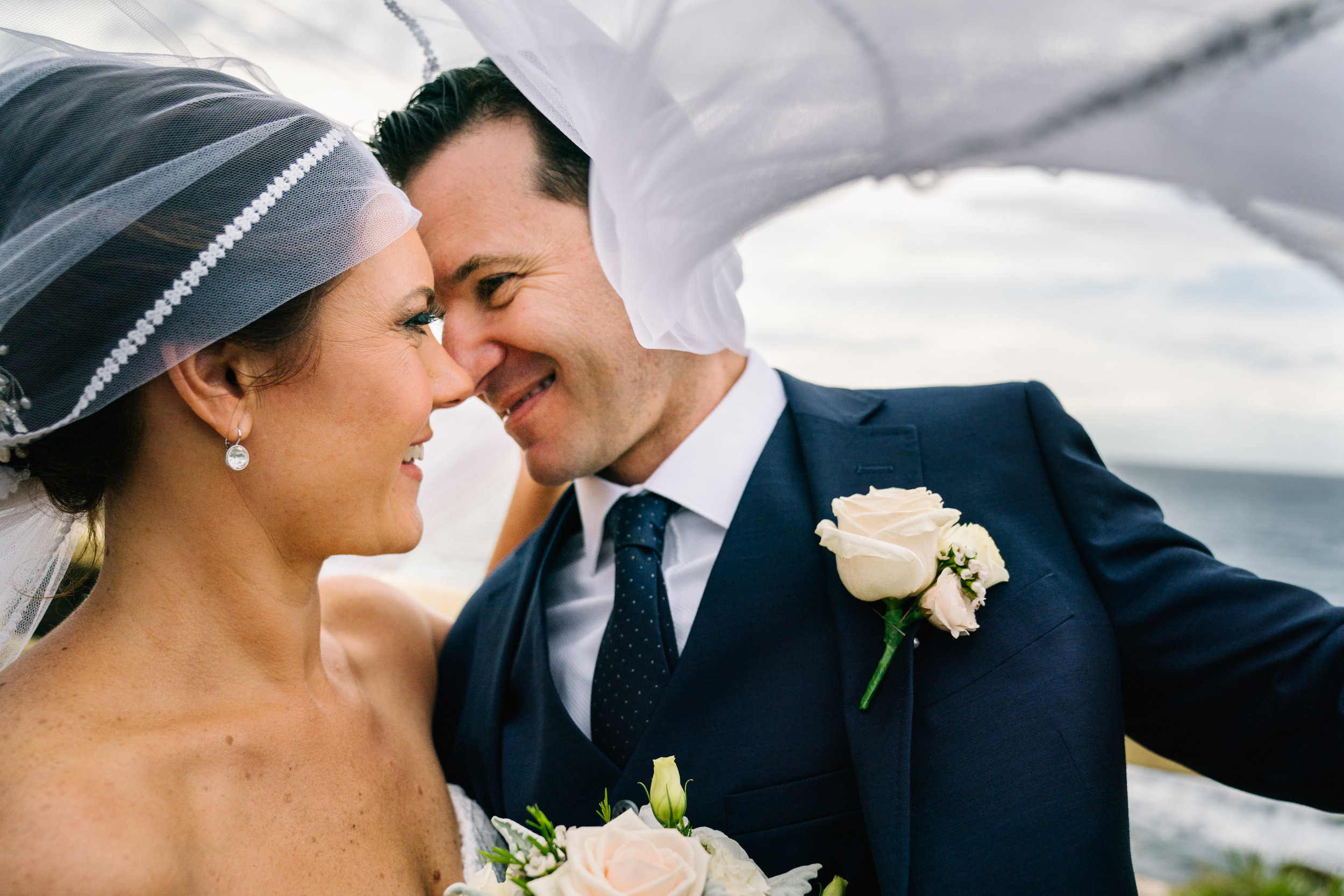 Bride and groom under veil