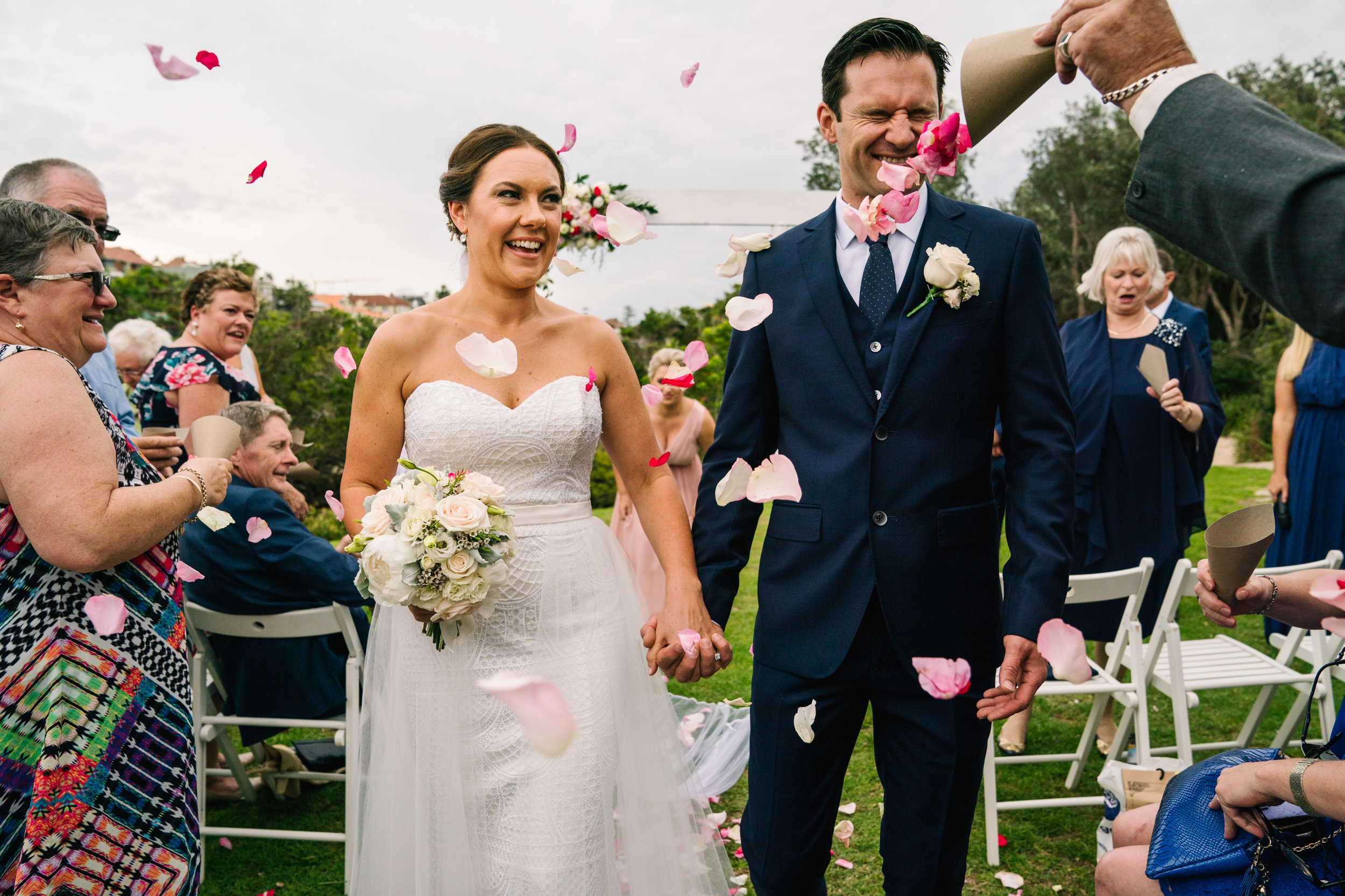 Flower petals being thrown in groom's face