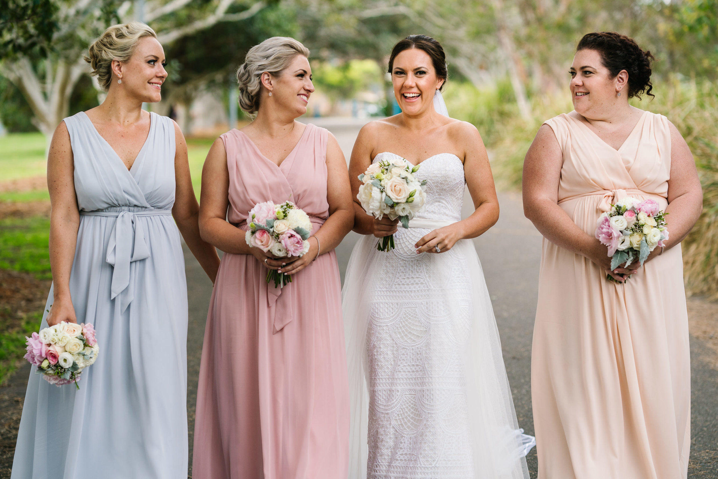 Bridesmaids in multicolour beach gowns