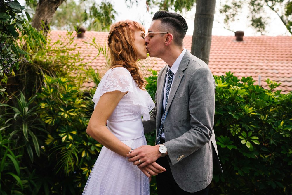 First kiss at hipster wedding ceremony