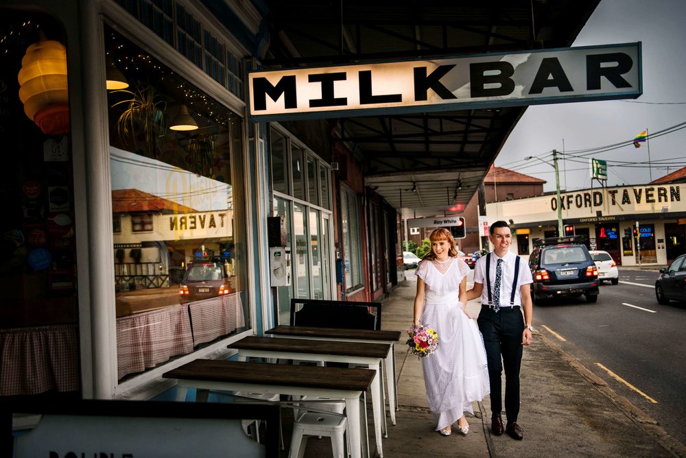 Newlyweds walking in front of Daisy's Milk Bar Petersham