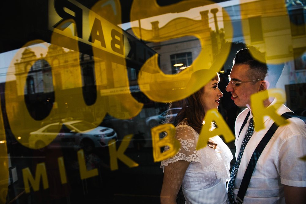 Bride and groom in window at Daisy's Milk Bar