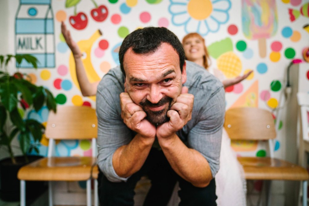 Wedding guest photobombing couple portraits