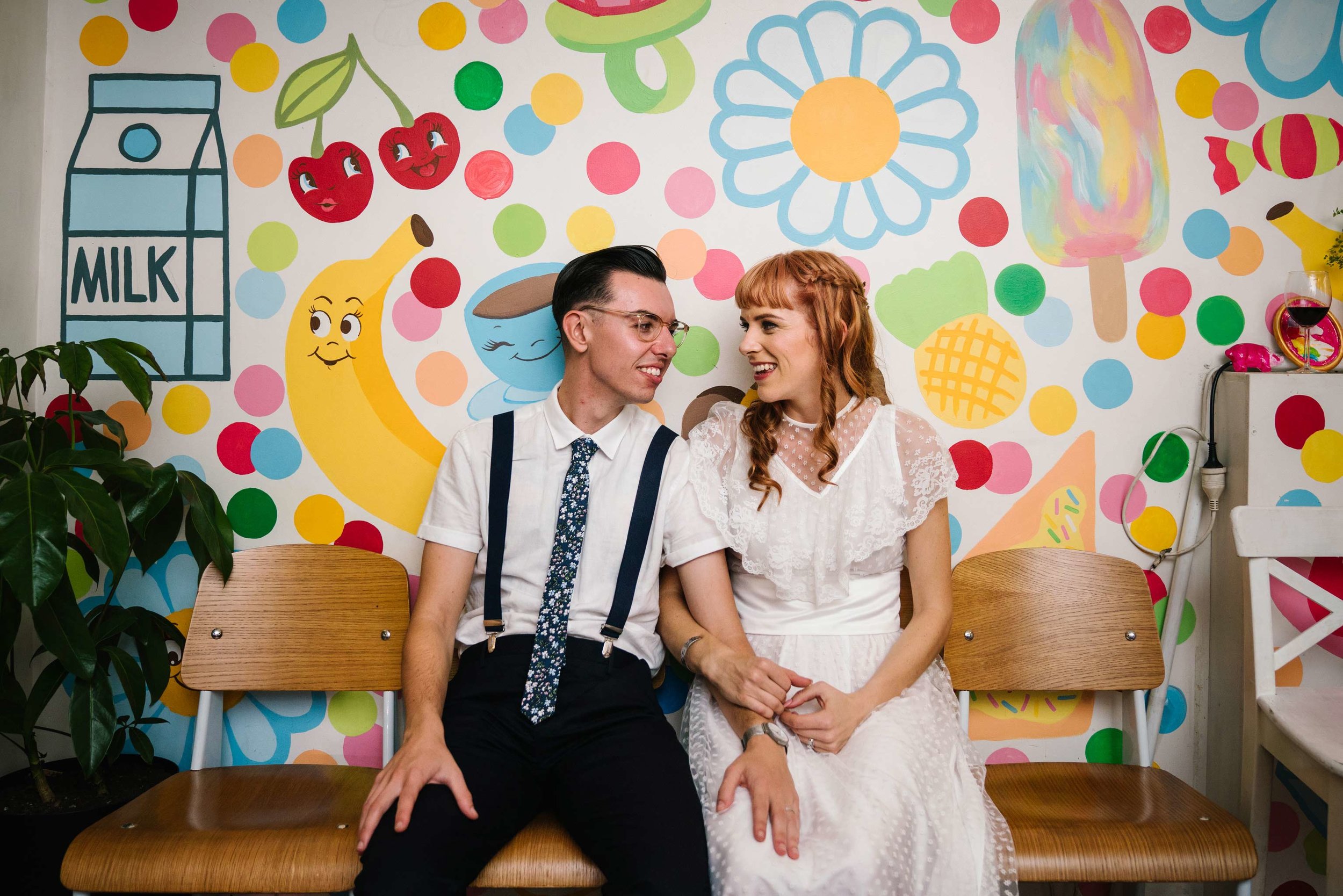 Couple posing in front of vintage mural