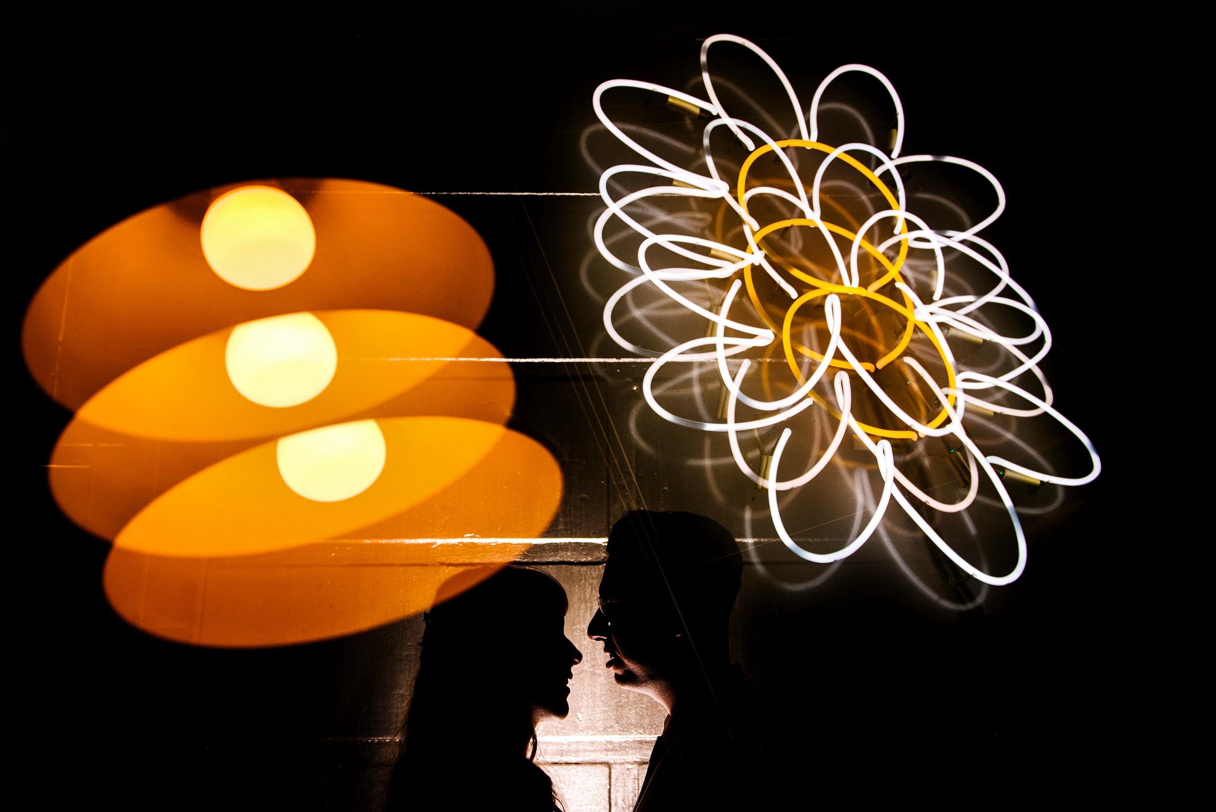 Silhouette of newlyweds with retro lighting in the background