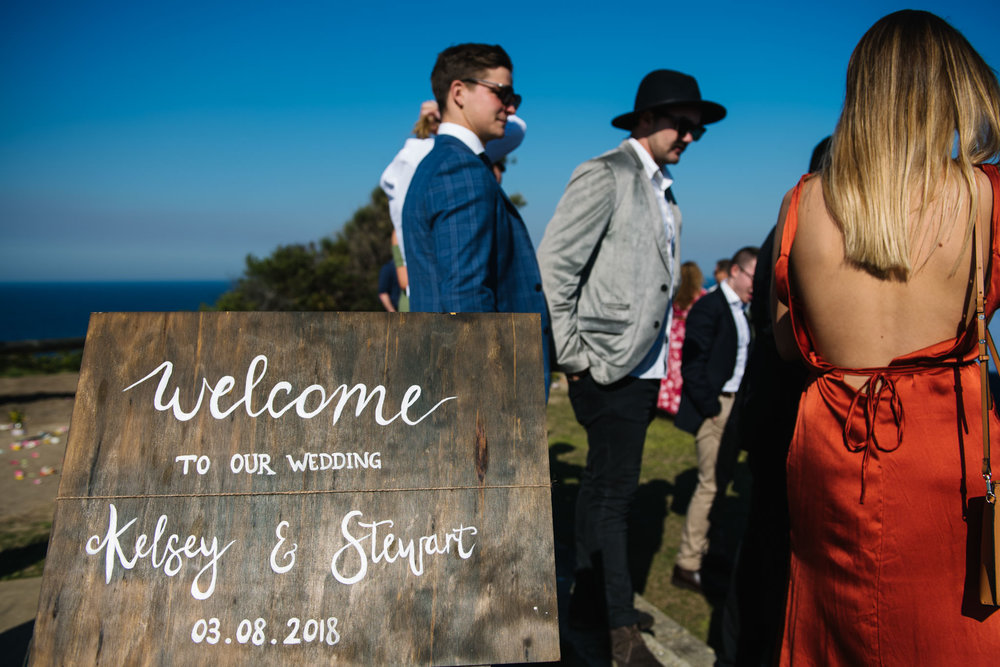 Wooden plaque with handwritten lettering detailing the wedding ceremony