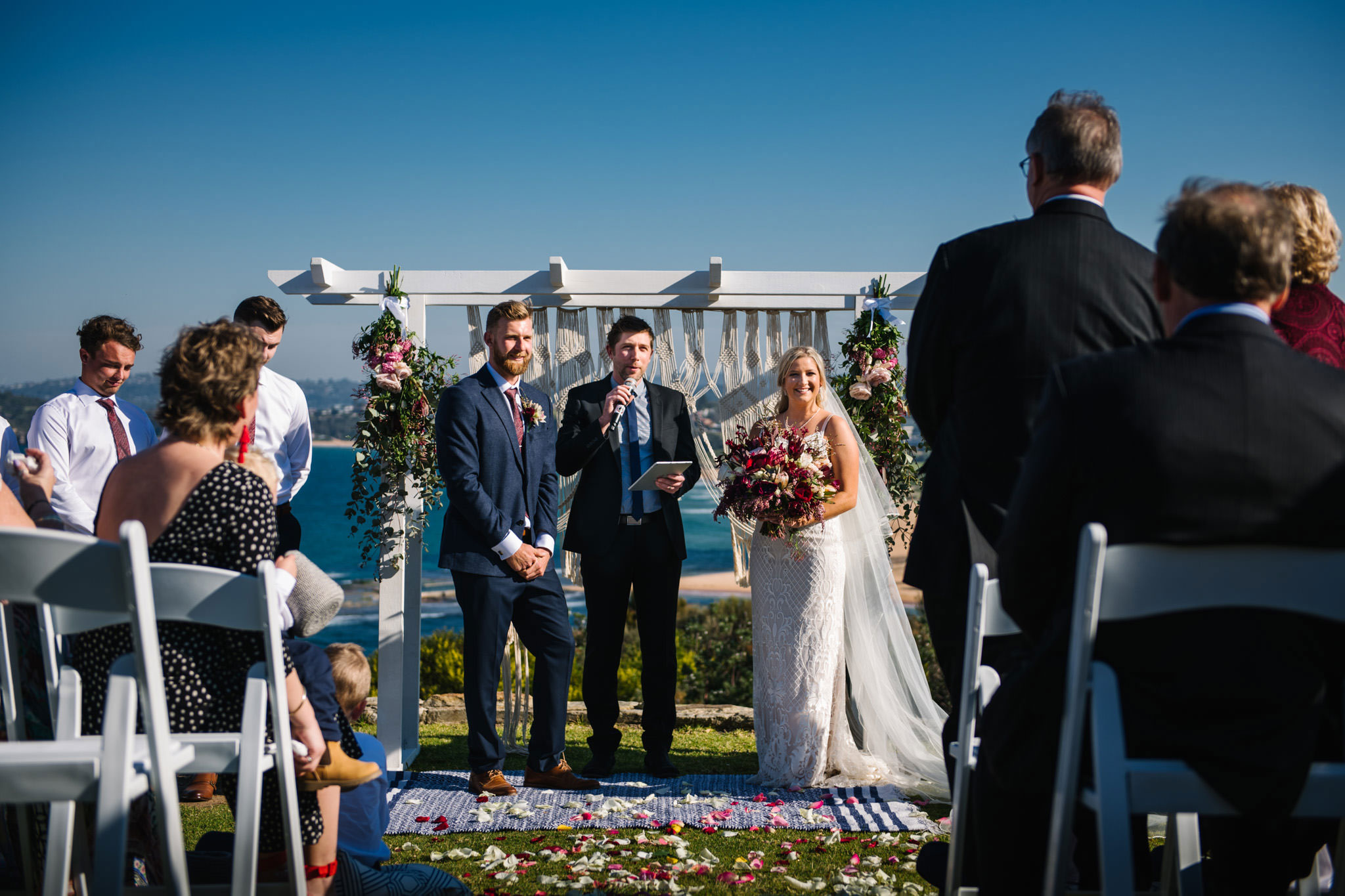 Bride and groom laughing during their Mona Vale Headland wedding ceremony