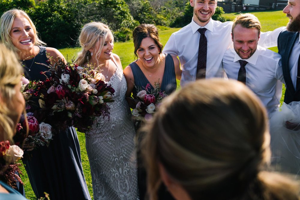 Bridal party embracing and smiling after ceremony
