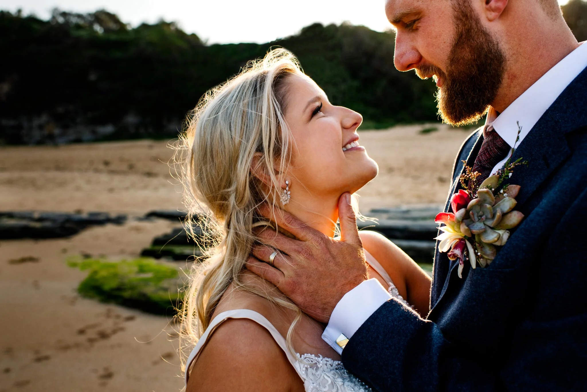 Close up of newlyweds gazing lovingly at each other on the beach