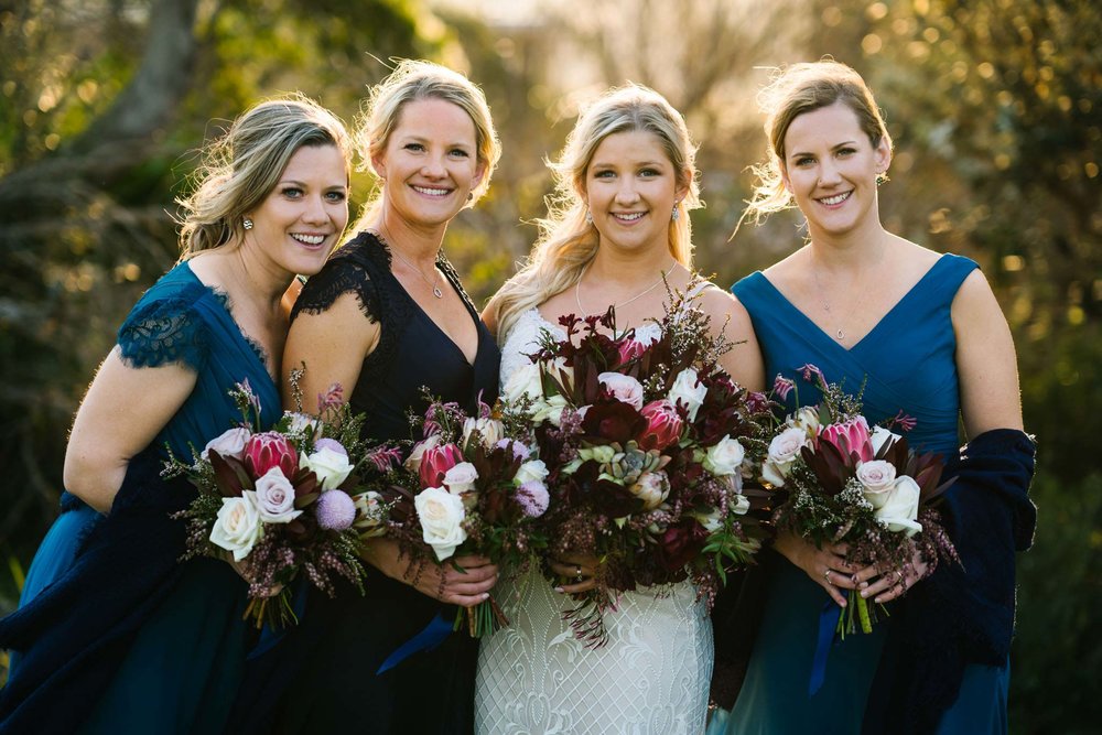 Bride with three sisters in blue bridesmaid dresses