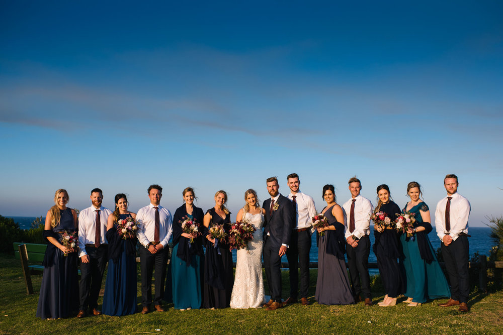 Large bridal party on lookout over Turimetta beach