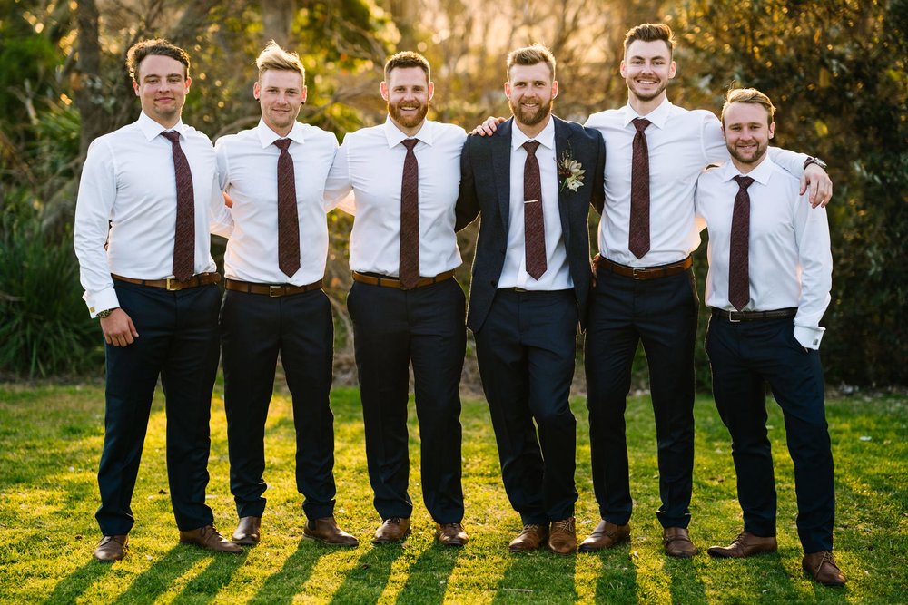 Groom with groomsmen in a park setting