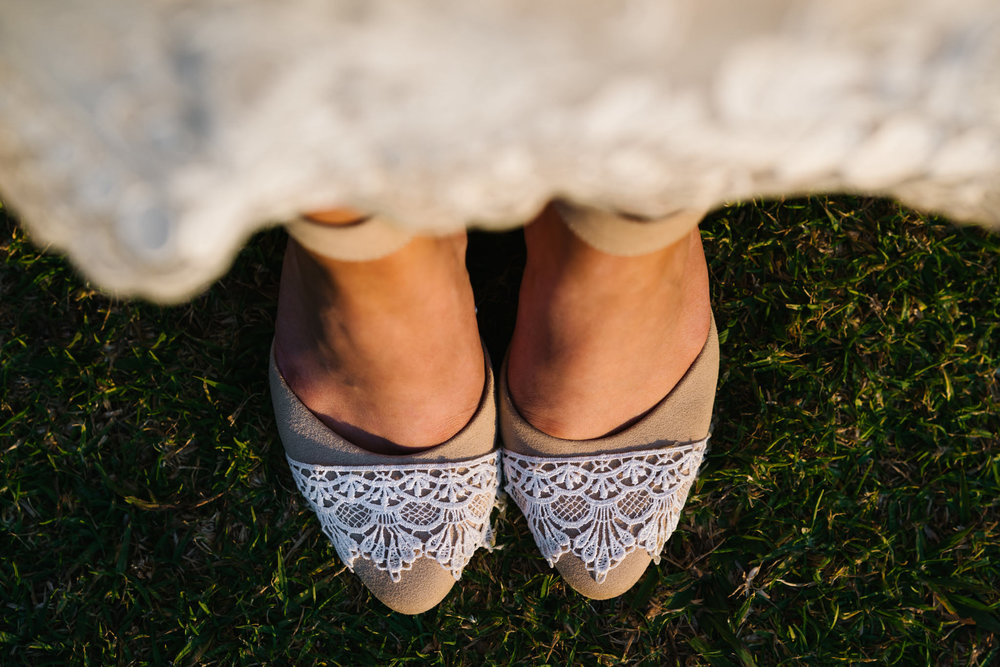 Detail of lace on the bride's beige shoes