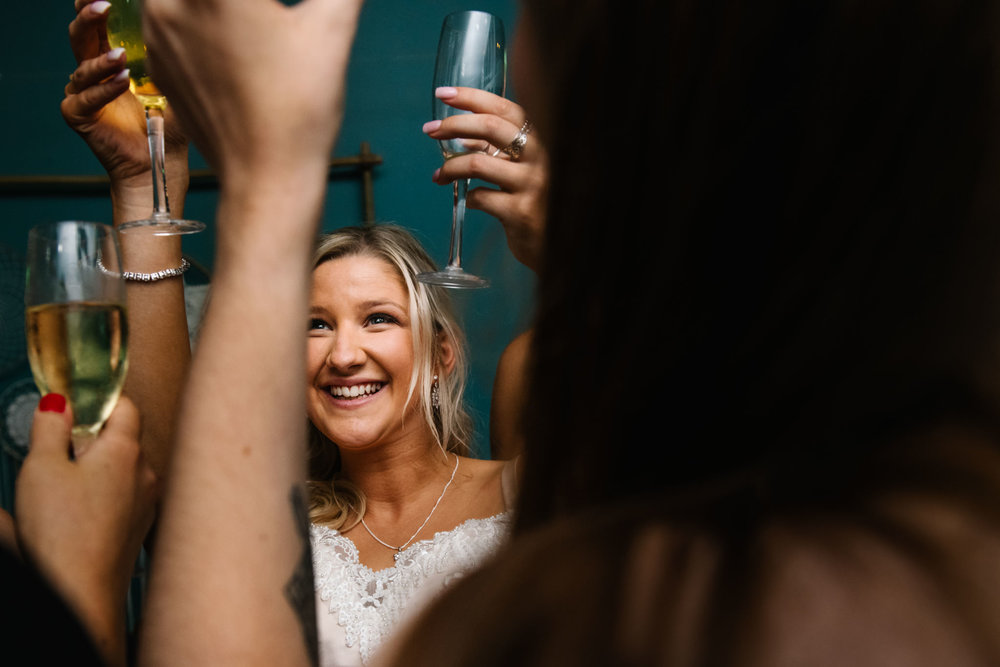 Bride doing a cheers with her guests