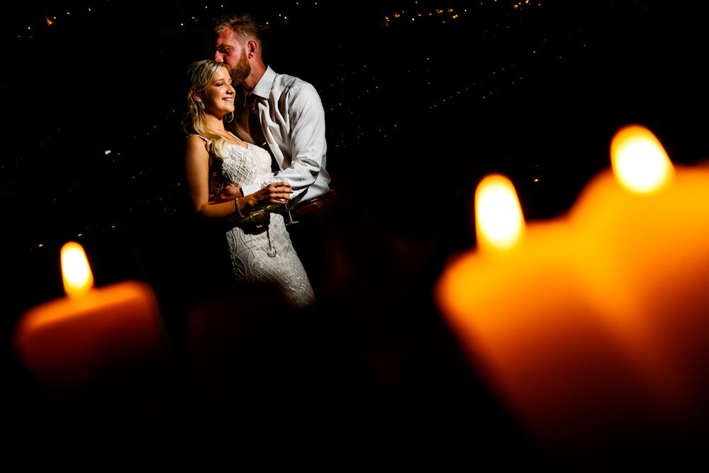 Portrait of newlyweds with candlelight in the foreground at Narrabeen Beach SLSC