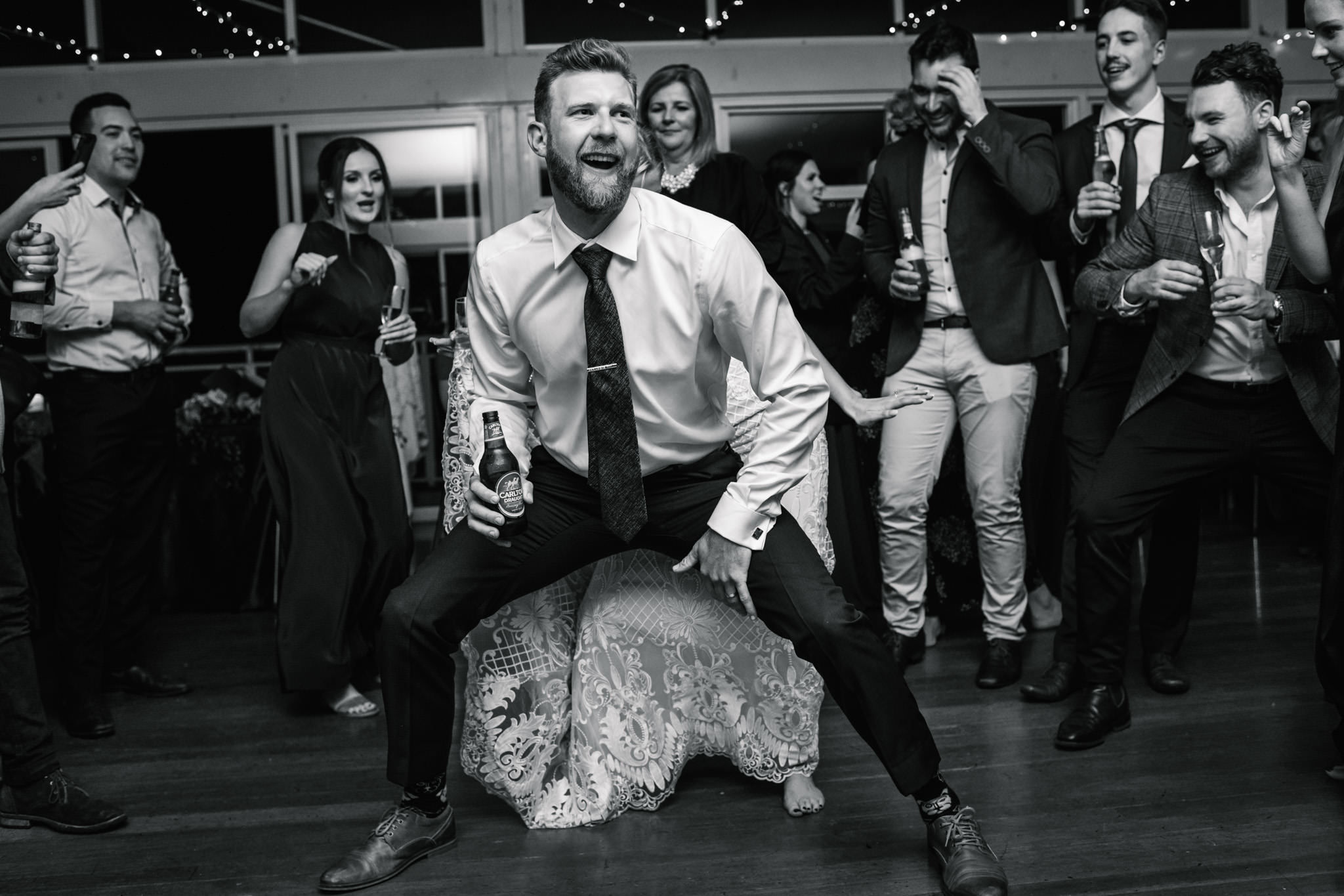Groom dirty dancing with bride at Narrabeen Beach SLSC