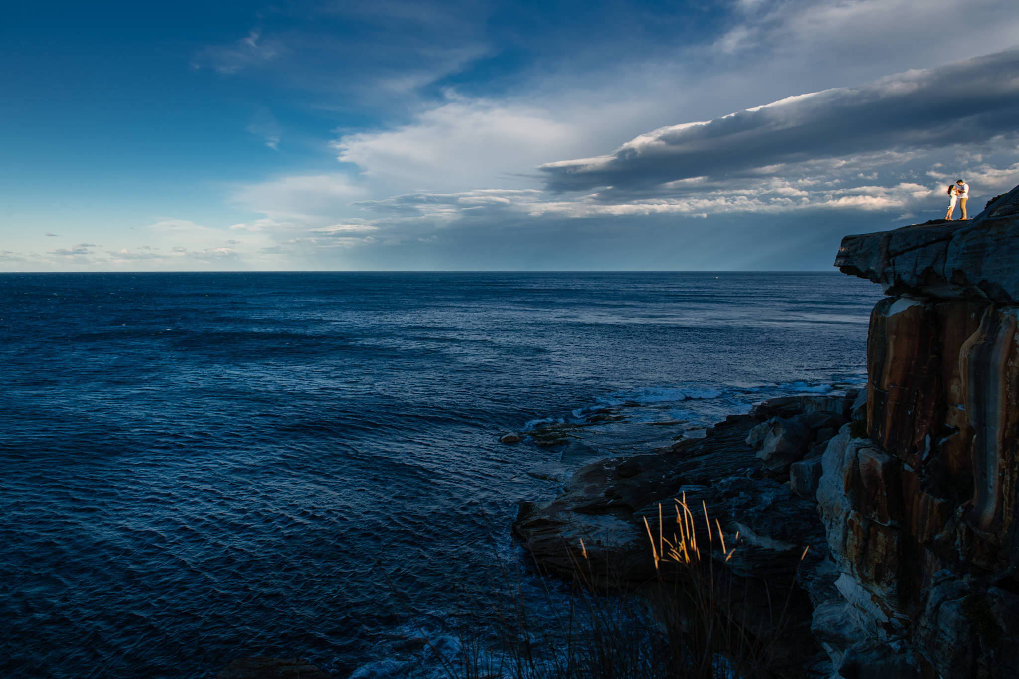 Panoramic view of the ocean from South head with couple dancing on a cliff top