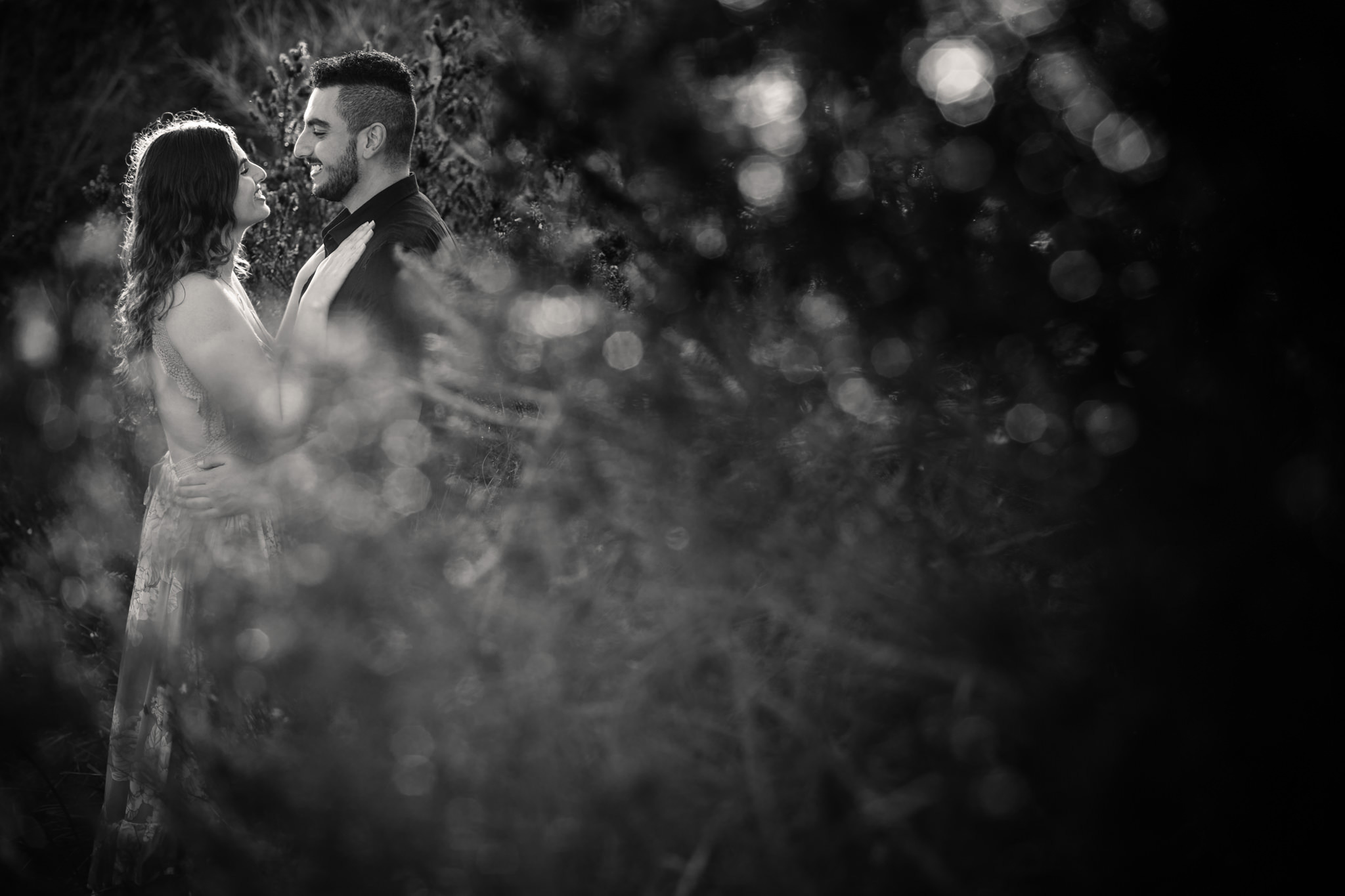 Engaged couple smiling at each other during Northern Beaches engagement session