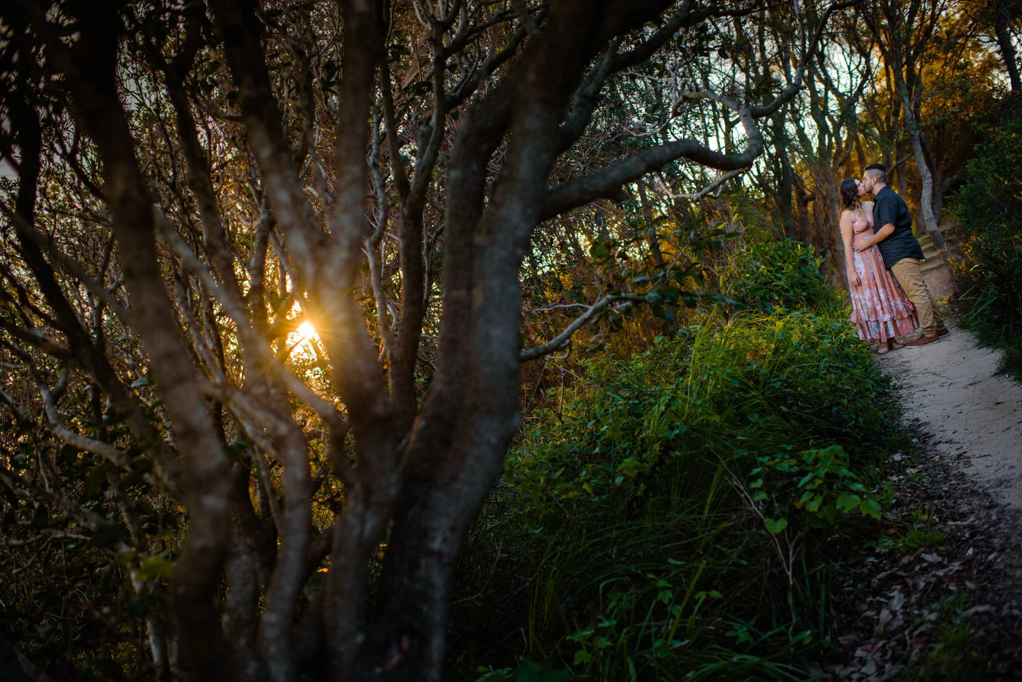 Engaged couple in woods near Turimetta Beach