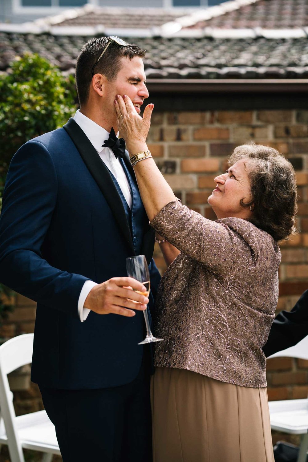 Grandmother playfully slaps groom on the cheek