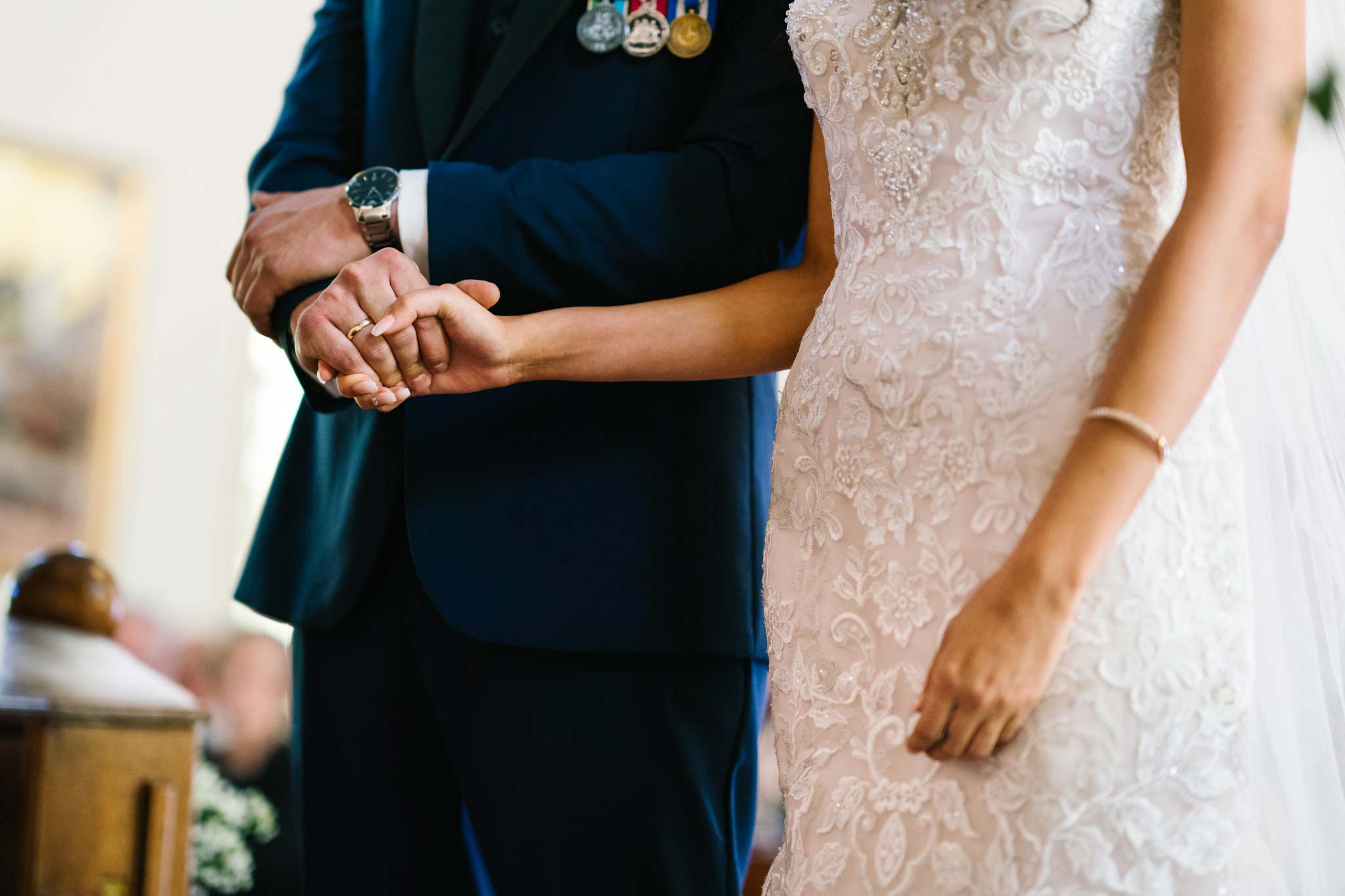 Bride and groom holding hands during wedding ceremony in Leichhardt, NSW