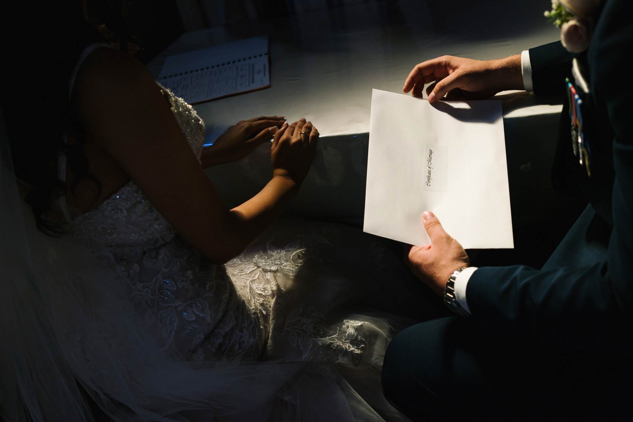 Newlyweds holding their marriage certificate