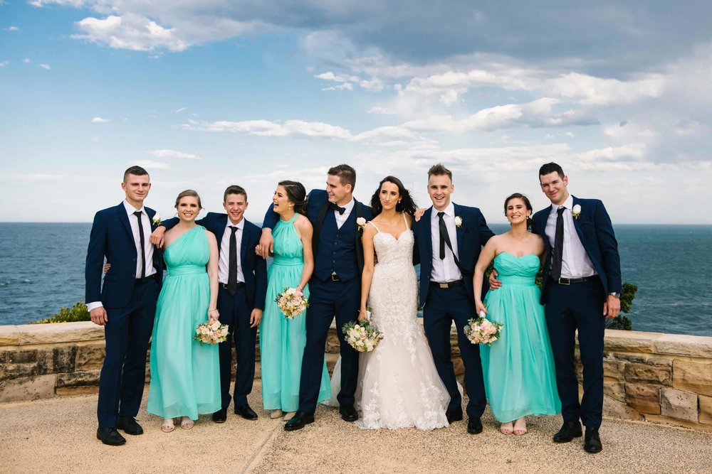 Bridal party laughing at Freshwater lookout in Sydney's Northern Beaches